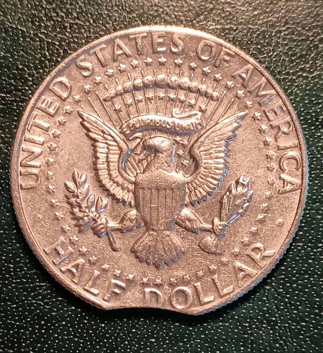 1997 Kennedy Half Dollar clipped planchet error showing arc-shaped missing metal section on one edge